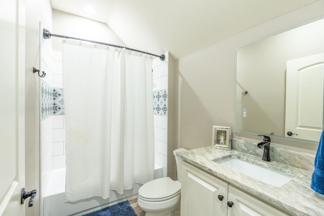 full bathroom with vanity, lofted ceiling, shower / tub combo with curtain, and toilet