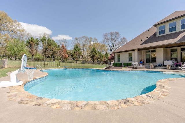 view of pool featuring a patio, a water slide, and an outdoor living space