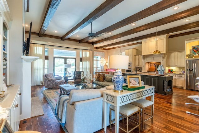 living room with beamed ceiling, sink, ceiling fan, and dark hardwood / wood-style flooring