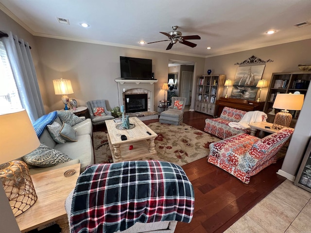 living room featuring ceiling fan, hardwood / wood-style flooring, and ornamental molding