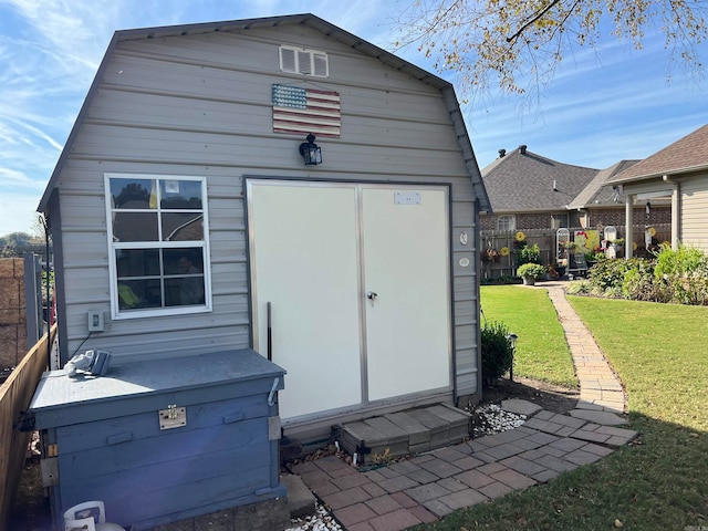 view of outbuilding with a lawn