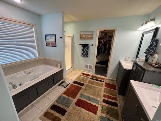 bathroom featuring vanity, tile patterned floors, and plus walk in shower