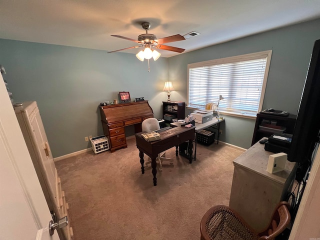 carpeted office space featuring ceiling fan