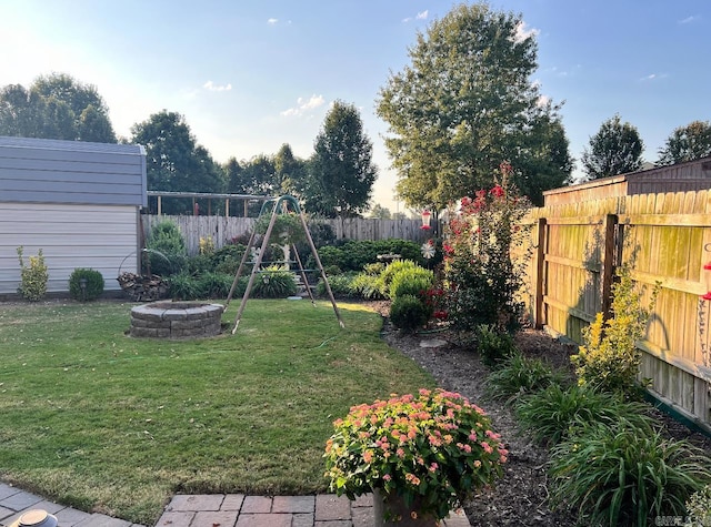 view of yard with a fire pit