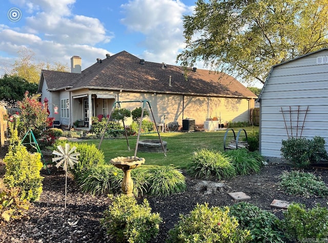 rear view of property with a lawn