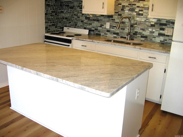 kitchen with white appliances, sink, a kitchen island, white cabinets, and dark wood-type flooring