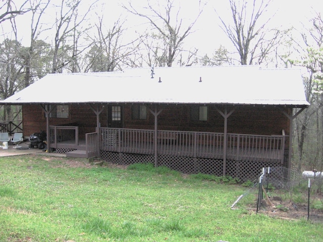 back of property featuring a yard and a wooden deck