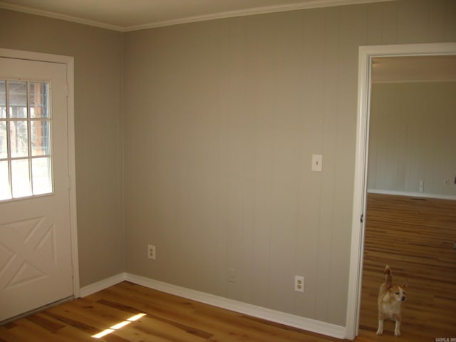 unfurnished room with crown molding and hardwood / wood-style floors