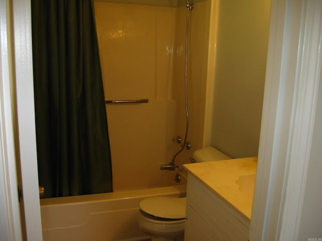 full bathroom featuring toilet, shower / tub combo with curtain, and vanity