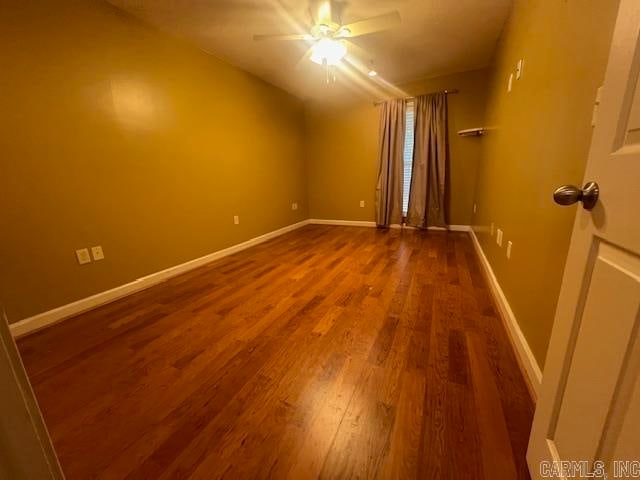 spare room with lofted ceiling, hardwood / wood-style flooring, and ceiling fan