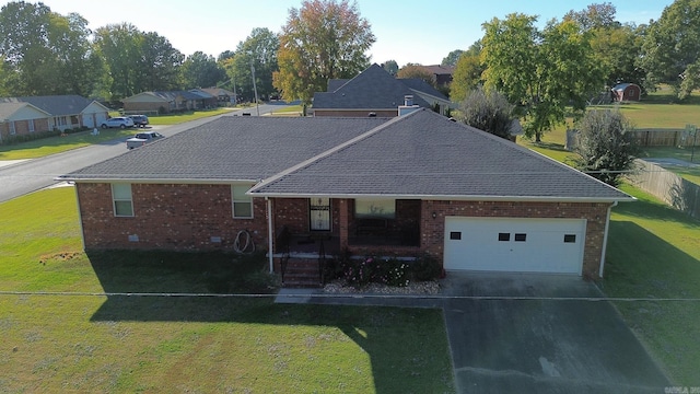 ranch-style home with a garage and a front lawn