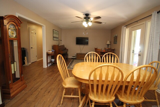 dining area with ceiling fan and hardwood / wood-style flooring