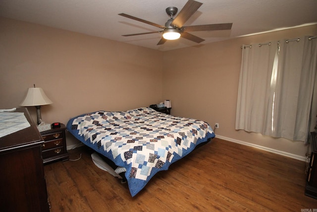 bedroom with dark hardwood / wood-style floors and ceiling fan