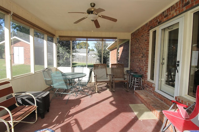 sunroom / solarium featuring ceiling fan