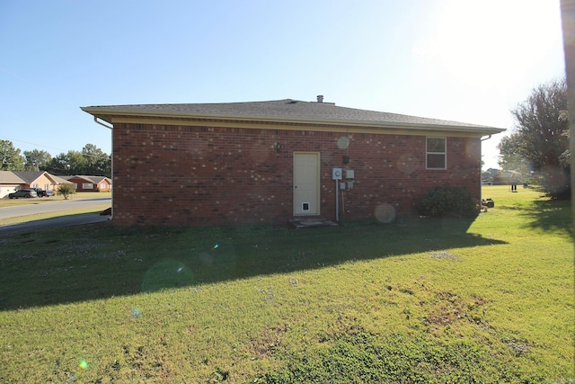 back of house with a lawn