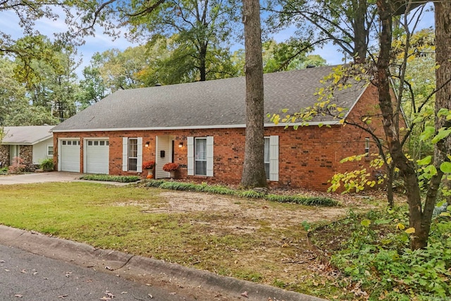 view of front of house featuring a garage and a front lawn