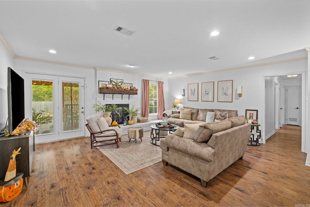 living room with hardwood / wood-style flooring, a fireplace, and a wealth of natural light