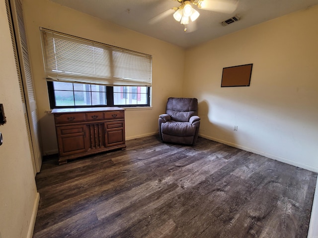 living area featuring ceiling fan, baseboards, dark wood-type flooring, and visible vents
