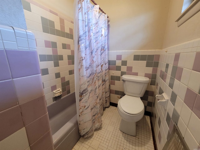 bathroom with tile walls, toilet, shower / tub combo with curtain, tile patterned floors, and a wainscoted wall