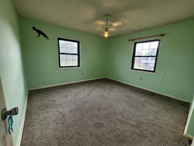 carpeted spare room with ceiling fan and a textured ceiling