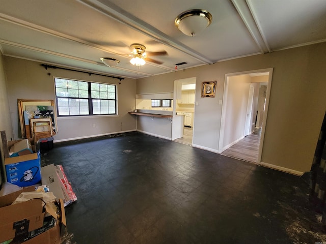 unfurnished living room with ceiling fan and beam ceiling