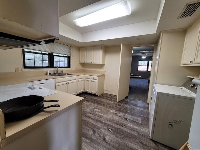 kitchen featuring washer and clothes dryer, white cabinetry, dark hardwood / wood-style flooring, and a healthy amount of sunlight