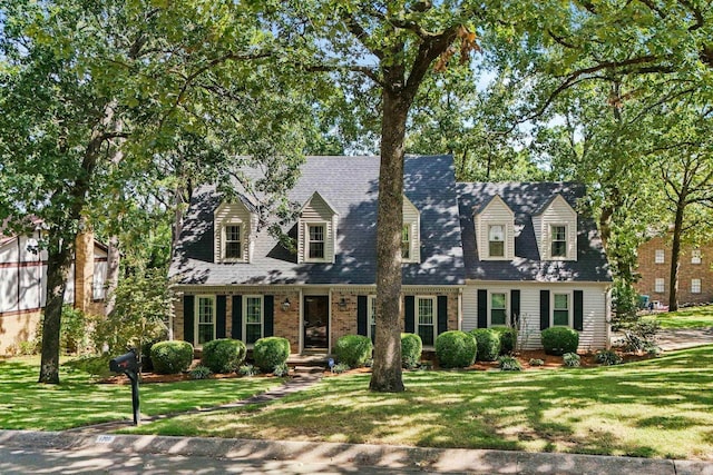 new england style home with a front lawn