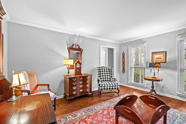 living area with ornamental molding and hardwood / wood-style floors