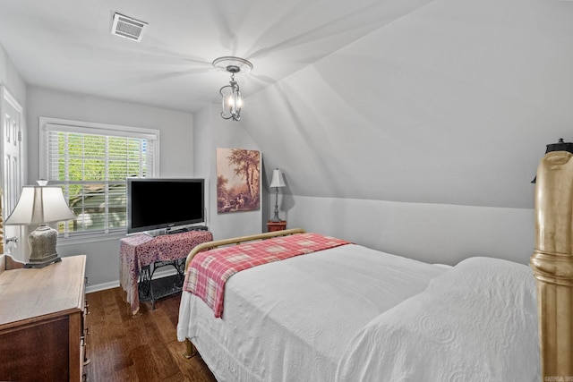 bedroom featuring lofted ceiling, a chandelier, and dark wood-type flooring