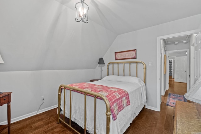 bedroom with vaulted ceiling and dark hardwood / wood-style floors