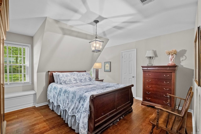 bedroom with dark wood-type flooring