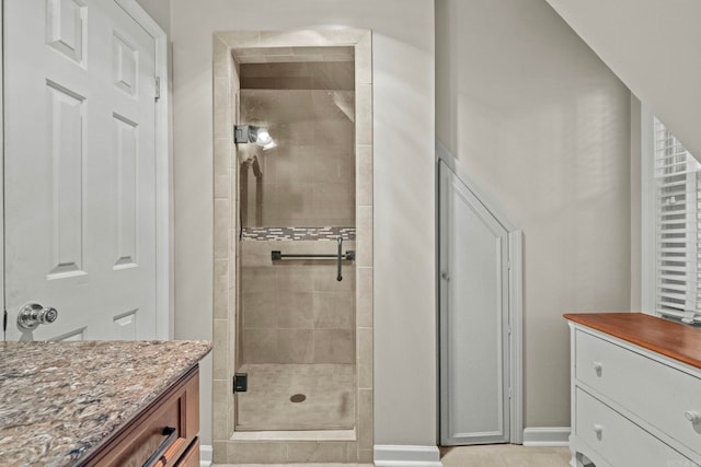 bathroom featuring vanity and tiled shower