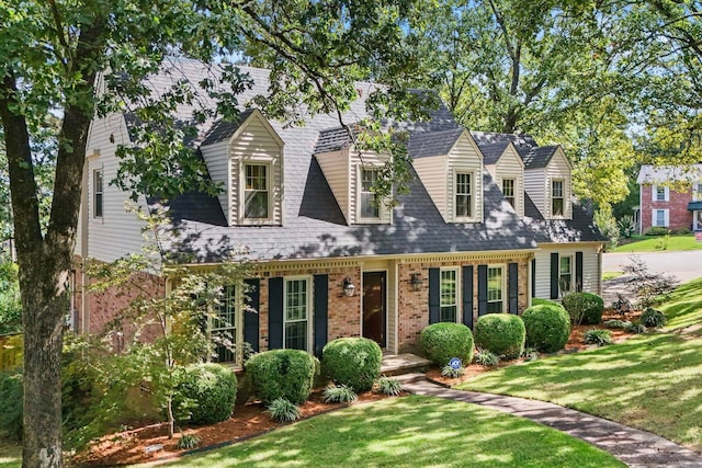 cape cod house with a porch and a front lawn