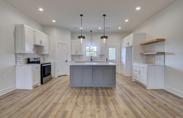 kitchen with white cabinetry, stainless steel electric range, and light hardwood / wood-style floors