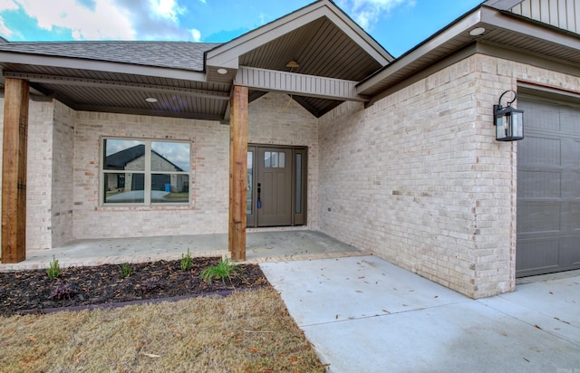 view of exterior entry featuring a garage