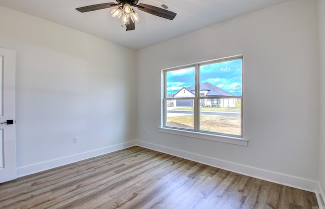 spare room with light hardwood / wood-style flooring and ceiling fan