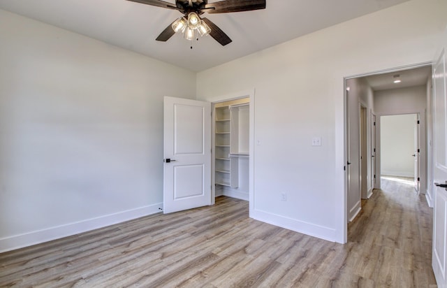 unfurnished bedroom with a closet, ceiling fan, and light wood-type flooring