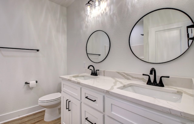 bathroom featuring vanity, hardwood / wood-style flooring, and toilet