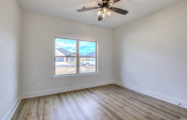 empty room with light wood-type flooring and ceiling fan