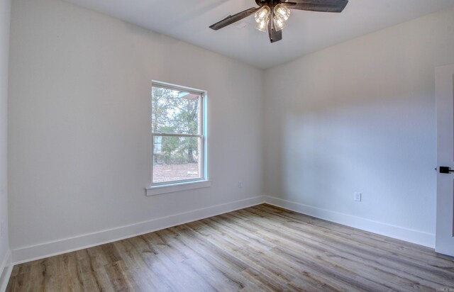 unfurnished room featuring light hardwood / wood-style flooring and ceiling fan