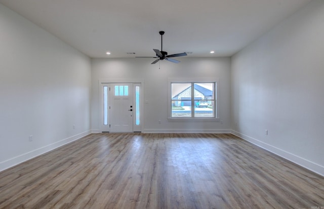 unfurnished living room with light wood-type flooring and ceiling fan