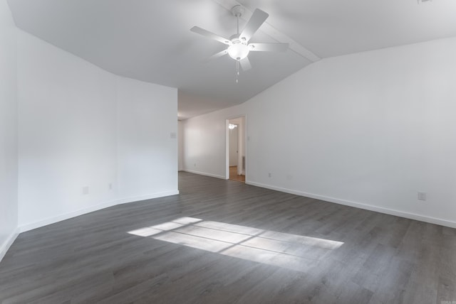 empty room featuring ceiling fan, dark wood-type flooring, and vaulted ceiling