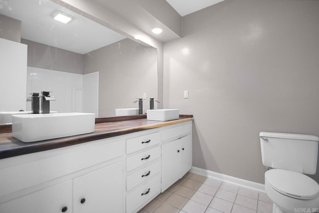 bathroom featuring vanity, toilet, and tile patterned flooring