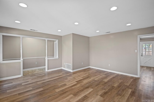 unfurnished room featuring hardwood / wood-style flooring