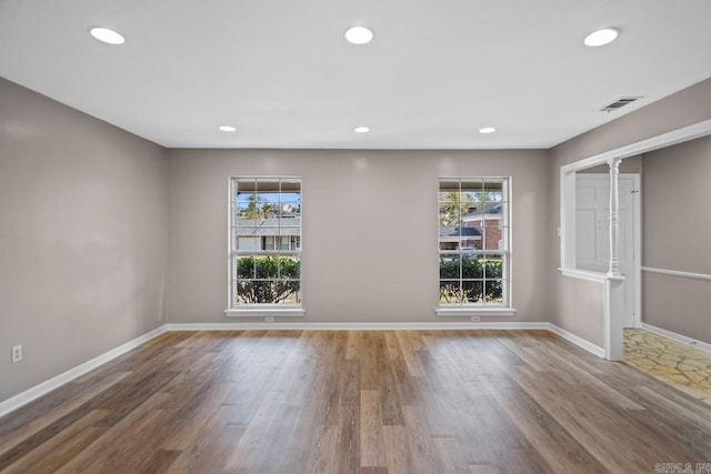 unfurnished room with hardwood / wood-style floors