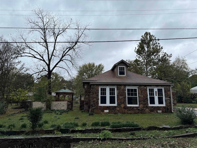 view of side of property with a yard and a gazebo