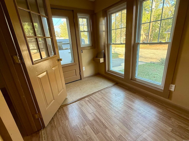 doorway to outside with light wood-type flooring