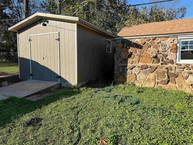 view of outdoor structure featuring a lawn