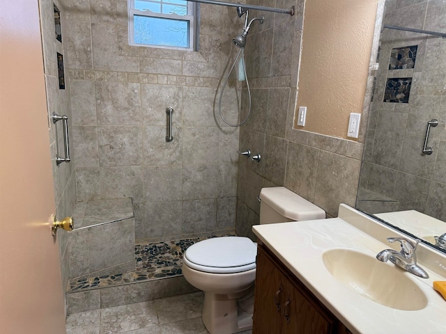 bathroom featuring toilet, tile walls, tile patterned flooring, an enclosed shower, and vanity