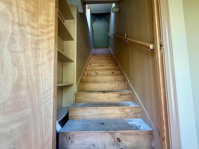 stairs featuring wood-type flooring